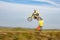 Man in red helmet riding a yellow motorbike on autumn track