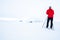 Man in red jacket doing cross country skiing during foggy weather in the mountains of Norway