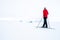 Man in red jacket doing cross country skiing during foggy weather in the mountains of Norway