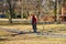 A man in a red jacket with a red backpack  on an electric unicycle with a helmet at Centennial Park