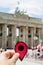 Man with a red marker in the Brandenburg Gate