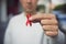 Man with red ribbon for the fight against AIDS