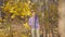 Man with red roses waiting for his beloved woman on a date in the autumn forest