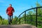 Man in red shirt runs on bridge in summer