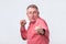 Man in red shirt standing in boxer pose with raised fists as if defending