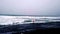 Man in red is standing and watching storm waves