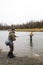 Man reeling in fish in alaska