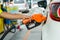 Man Refill and filling Oil Gas Fuel at station.Gas station - refueling.To fill the machine with fuel. Car fill with gasoline at a