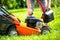 Man refueling the lawnmower on his huge garden, gardening concept