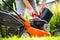 Man refueling the lawnmower on his huge garden, gardening concept