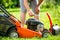 Man refueling the lawnmower on his huge garden, gardening concept