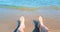 Man in relax stay with his feet on tropical caribbean beach sea with gold sand, holiday, relax and travel