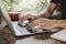 Man relaxed working on digital laptop computer with red coffee cup