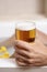 Man relaxing in the bathtub with a beer