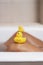 Man relaxing in the bathtub with rubber ducks