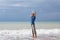 Man relaxing on the beach and the oncoming wave