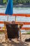 A man relaxing in a deckchair with a glass of beer looking into the sun