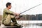 Man relaxing fishing or angling at lake
