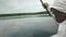 Man relaxing with fishing rod on lake. Male fisherman holds fishing rod on background of lake. Man on recreation with fishing rod