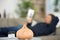 man relaxing reading book as diffuser emits essential oils