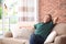 Man relaxing on sofa with comfortable pillows