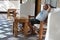 Man relaxing on a veranda on a bamboo sofa