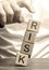 Man removes blocks with the word Risk. The concept of reducing possible risks. Insurance, stability support. Legal protection of