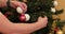 A man removes Christmas toys from a tree in