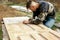 A man removes paint with a spatula from the door.the guy is engaged in carpentry, restoring wooden doors