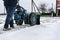 A man removes snow with the help of a motorcycle cultivator