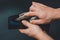 Man removing dollars from his wallet, hands and wallet on black background