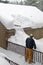 Man removing snow from roof