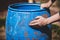 Man renew and upcycling a barrel with sandpaper