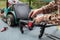 A man is repairing a battery-powered lawnmower. The electric toggle switch to start the engine is defective and needs to be