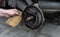 The man repairing brake drums for car and cleans brake pads with sandpaper