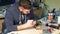 Man repairing broken device in workshop