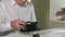 A man is repairing a coffee-making unit of a coffee machine, repair shop of coffee makers