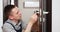 a man repairing a door knob. locksmith fixing a wooden door.