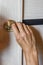 Man repairing the doorknob. closeup of worker`s hands installing new door locker