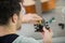 man repairing guitar with pliers