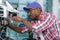 Man repairing photocopier using screwdriver