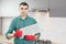 Man repairs range hood in the kitchen. Replacement filter in a cooker hood.