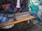 Man repairs shoes on the footpath, cobbler repairing shoes in small shop