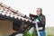 Man repairs tiled roof of house close up