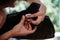 A man repairs a trimmer. A man repairs a lawnmower in close-up