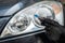 man replacing a h7 halogen burnt out lamp in auto headlight