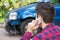 Man Reporting Car Crash On Mobile Phone