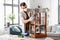 man in respirator sanding old table with sponge