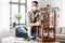 man in respirator sanding old table with sponge