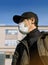 Man in respirator in urban scape, pandemic virus protective mask, air pollution problem